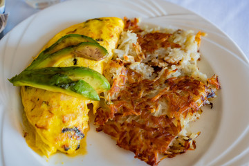 Close up shot of a breakfast with has browns and fried egg