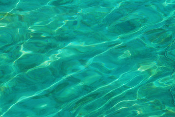 Surface of swimming pool, green water reflection.