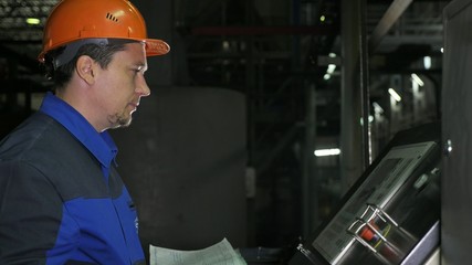 Operator monitors control panel of production line. Manufacture of plastic water pipes of the...
