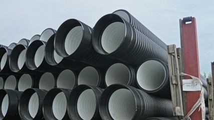 Warehouse of finished plastic pipes industrial outdoors storage site. Manufacture of plastic water...