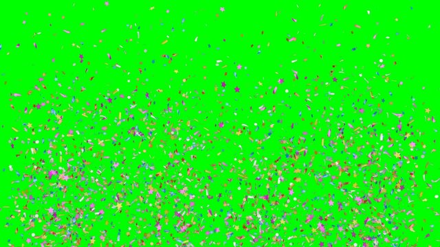 Multicolored festive confetti explosions falling on a green background. Slow motion footage.