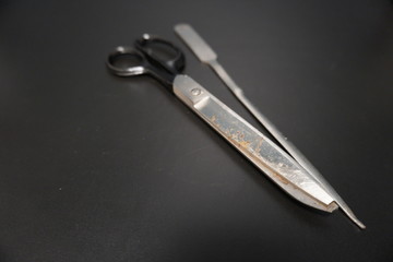 rusty and broken tip scissors and mail opener in office supply