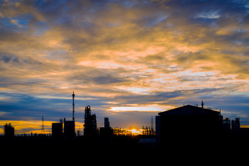 Fototapeta na wymiar Silhouette image of petrochemical industry or Oil and gas refinery plant with sunset sky