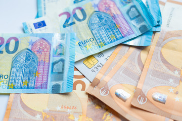Euro money with credit card on white background