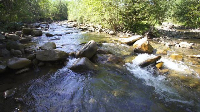 4K landscape. Beauty of nature. Mountain river, stream flow  and stones.
