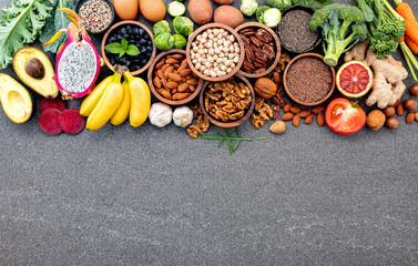 Ingredients for the healthy foods selection. The concept of healthy food set up on dark stone background.