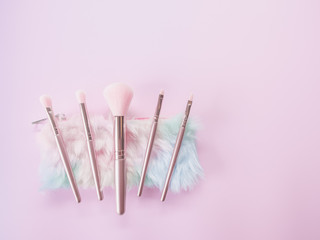 Beauty and Makeup concept from facial cosmetics, blush brush, brow brush, highlighter palette and...