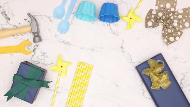 Blue Birthday decoration for boys with gifts, candles, bows appear on white background - Stop motion 