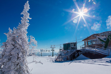 Beautiful winter landscape with trees ans ski lift.