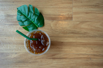 Green leaf coffee with top view. Green tube. Bright brown background to the left.