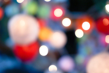 Blurred and bokeh reflection lighting of lights decorating the Christmas tree around beautifully.