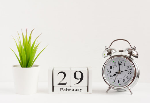February 29 on a wooden calendar next to the alarm clock.Calendar date, holiday event or birthday.The last day of the winter month. February 29 happens every four years.