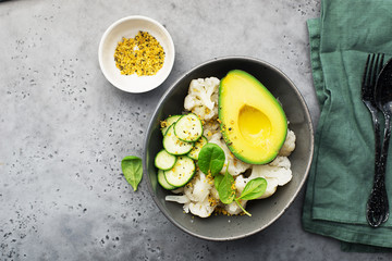 Healthy food. Fresh green salad on black background, top view