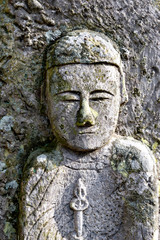 Fototapeta na wymiar A stone image of the Buddha at Rakan-ji temple in Kasai city, Hyogo prefecture, Japan