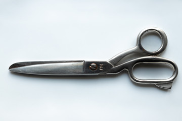 background. large steel scissors on a white background