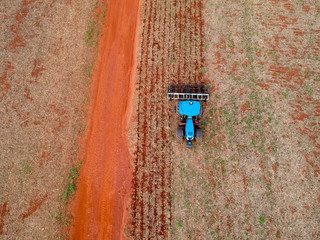 Aerial view of a tractor harrowing the soil to plant soybeans in Brazil