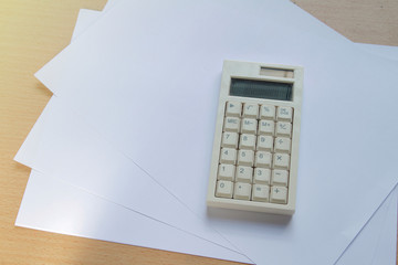 calculator with papel on office desk background