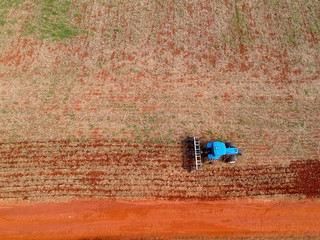Aerial view of a tractor harrowing the soil to plant soybeans in Brazil
