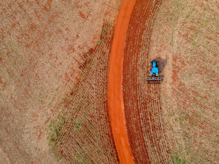 Aerial view of a tractor harrowing the soil to plant soybeans in Brazil