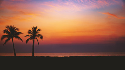 Fototapeta na wymiar Silhouette Palm Trees By Sea Against Romantic Sky At Sunset