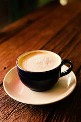 cup of coffee on wooden table