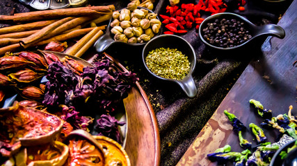 Top view Thai spices and herbs ingredient decoration on wood table for cook in home kitchen. 
