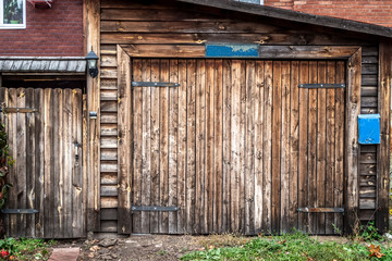 The faded gate of an old wooden house.