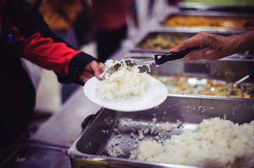 Beggars receive warm and delicious food from the donor's hands: the concept of food beggars