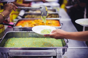 Beggars receive warm and delicious food from the donor's hands: the concept of food beggars