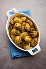 Jeera Aloo - Potatoes Flavoured With Cumin seeds and spices. popular Indian main course recipe. served in a bowl. selective focus