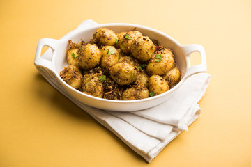 Jeera Aloo - Potatoes Flavoured With Cumin seeds and spices. popular Indian main course recipe. served in a bowl. selective focus