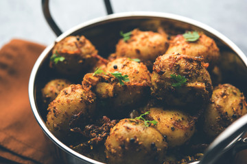 Jeera Aloo - Potatoes Flavoured With Cumin seeds and spices. popular Indian main course recipe. served in a bowl. selective focus