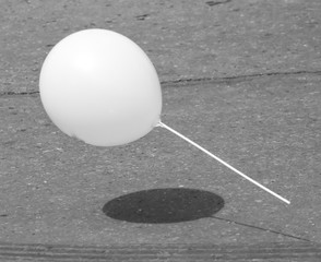 A white ball flies over the road