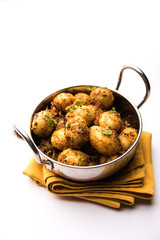 Jeera Aloo - Potatoes Flavoured With Cumin seeds and spices. popular Indian main course recipe. served in a bowl. selective focus