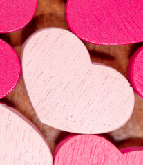 Pink wooden hearts as a background