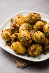 Jeera Aloo - Potatoes Flavoured With Cumin seeds and spices. popular Indian main course recipe. served in a bowl. selective focus