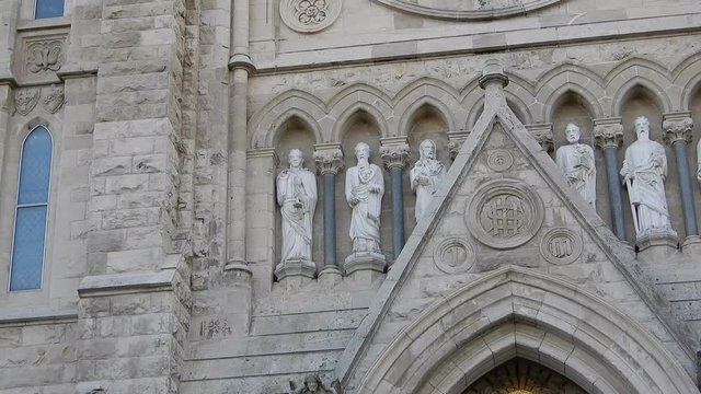 Closeup Of Statues On Grey Stone Church Building Left To Right Panorama