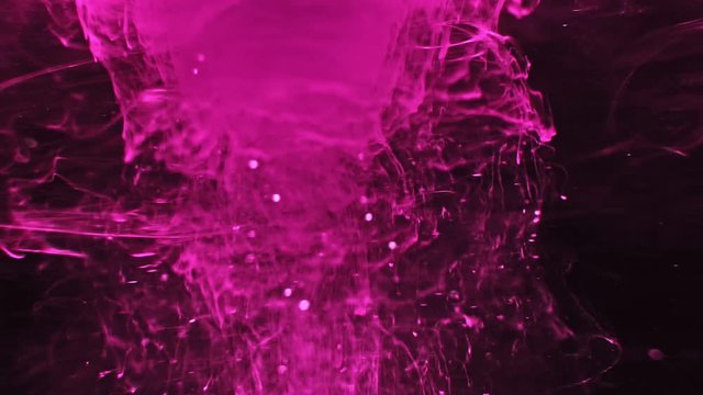 Paint fall into water which is twist. Spin acrylic ink drip into liquid. Visual effect bullet time, frozen moment, flow motion. Cloud fraction of color is spray drop. Slow motion cosmic video magic.