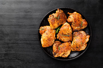 Grilled chicken thighs with spices and lemon. Top view