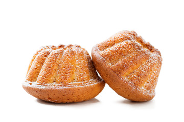 Mini bundt cakes or muffins with icing sugar isolated on white background.