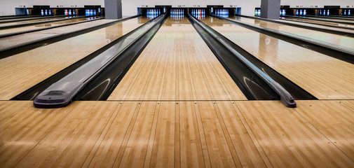 Close up of bowling balls, bowling pins bowling balls in a row.