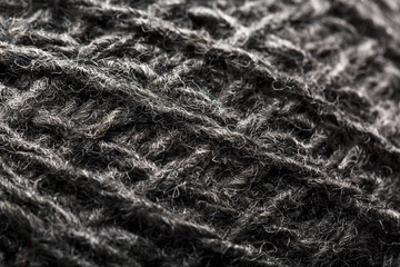 Wool yarn close-up gray threads for needlework in macro. Background texture fabric for knitting needle.