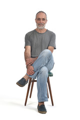 portrait of middle aged man sitting  on white