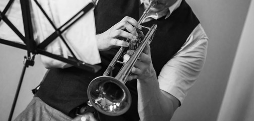 Obraz premium Trumpet in musician hands. Retro stylized
