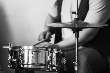Fototapeta na wymiar Live music background, drummer plays with drumsticks