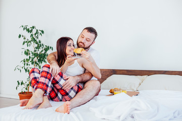 man and woman breakfast in bed morning