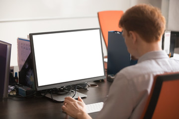 Fototapeta na wymiar Rear side view employee working on computer sitting at workplace