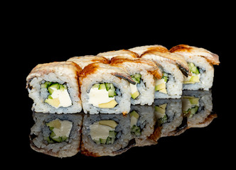 sushi and rolls with different fillings on a black background with reflection