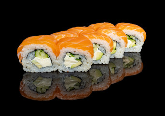 sushi and rolls with different fillings on a black background with reflection