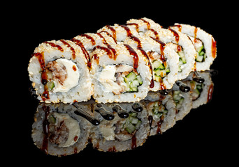 sushi and rolls with different fillings on a black background with reflection